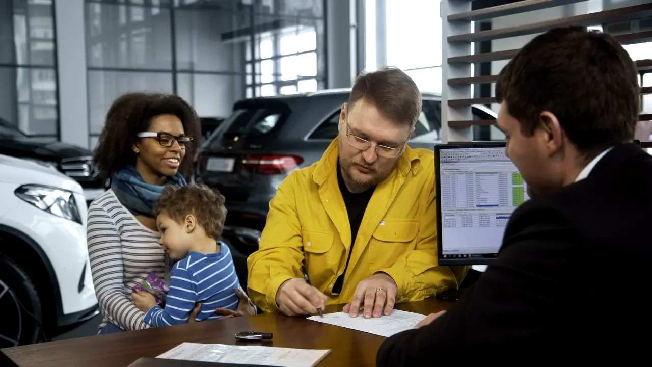 Insurance agent walking a family through their policy options at a desk