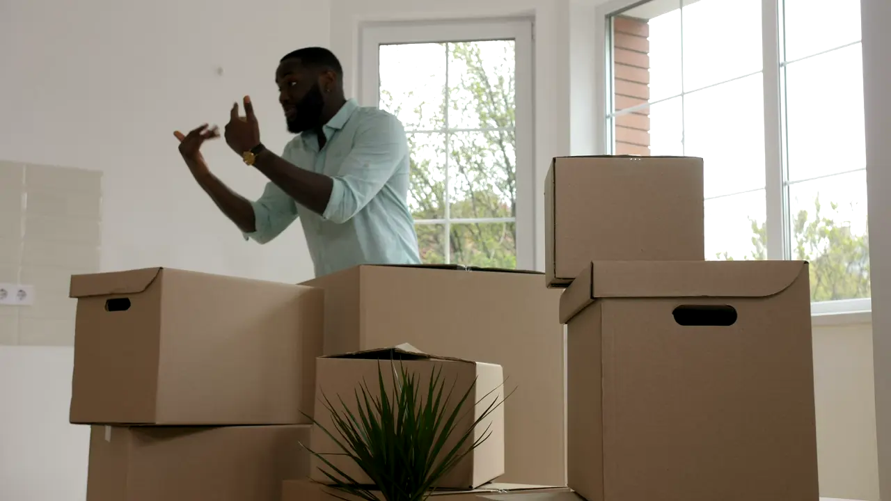 Moving boxes stacked in a bright new apartment